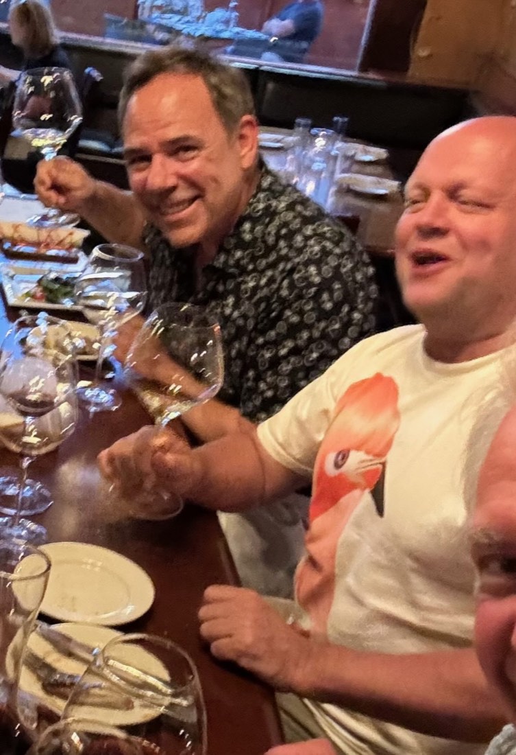 Gerry laughing with a friend at dinner