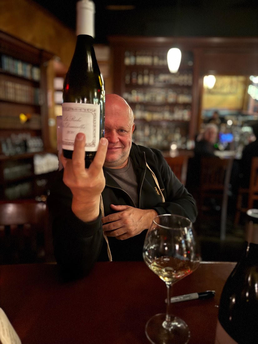 Gerry at the tavern with a bottle of white