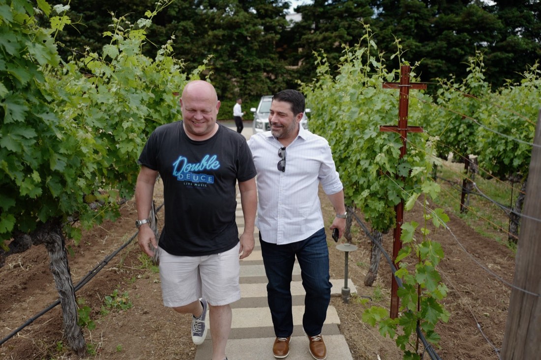Gerry walking a Napa vineyard with a friend